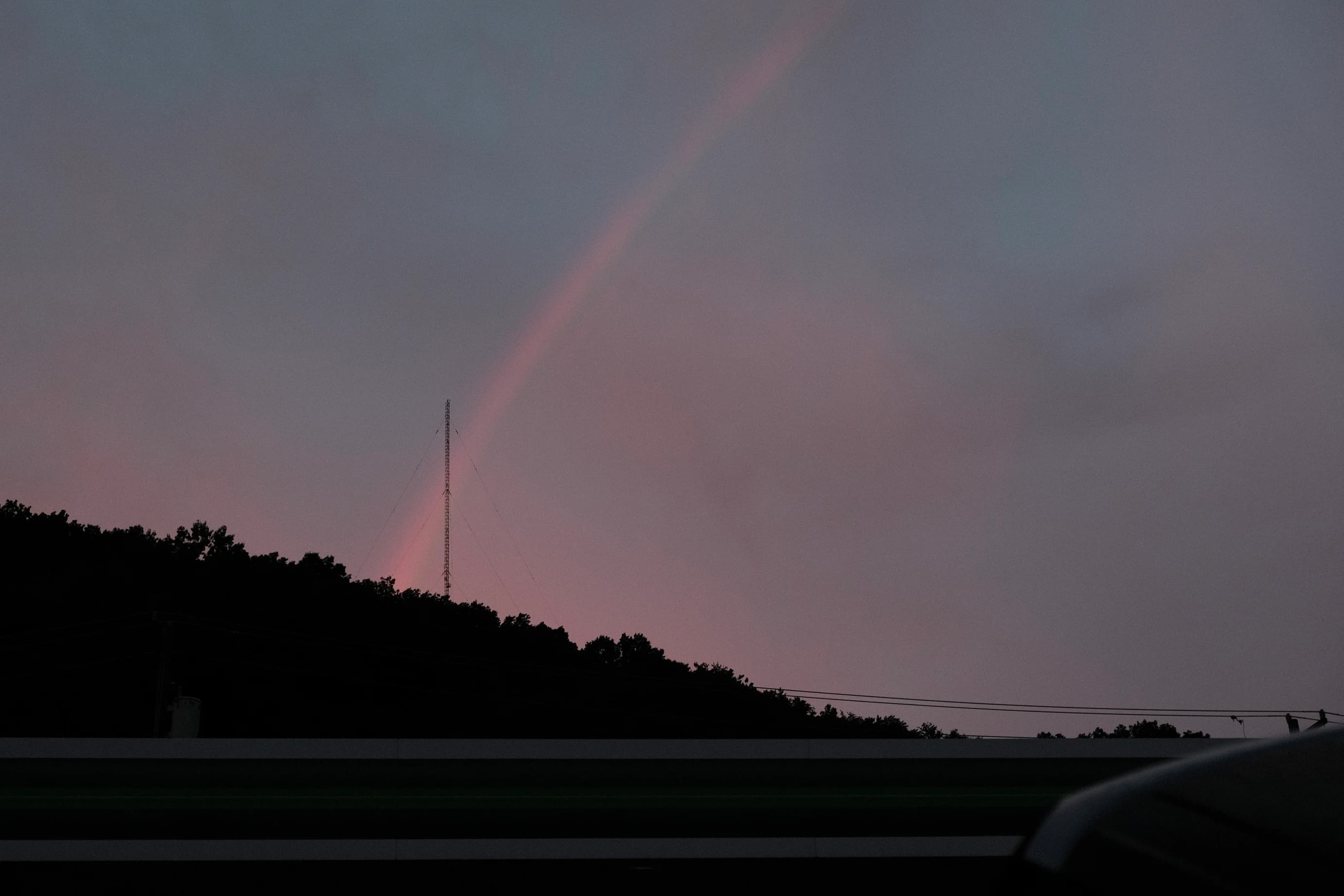 Rainbow falling on dark mountain