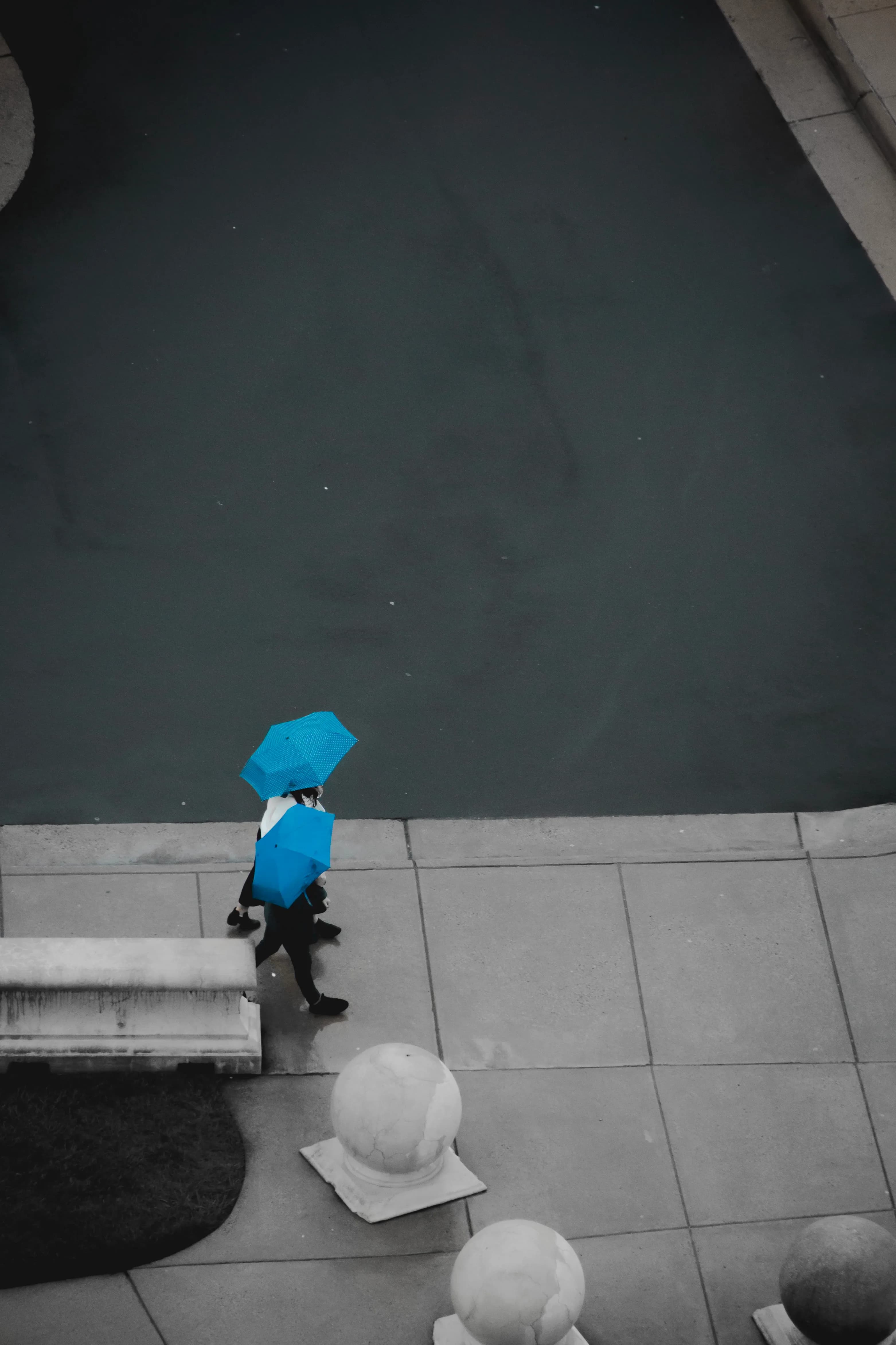 Two people with blue umbrellas
