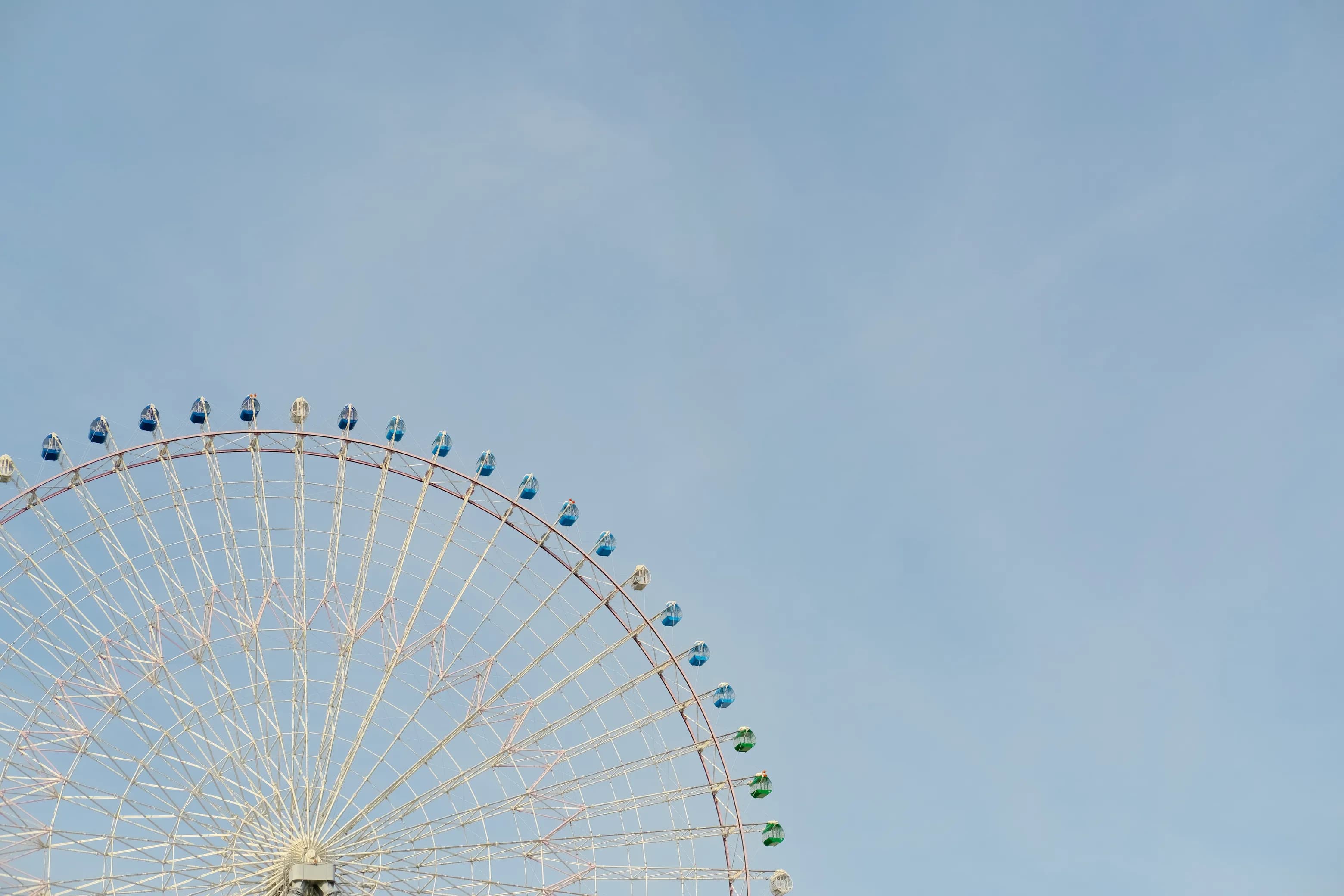 Ferris wheel with blue sky backdrop